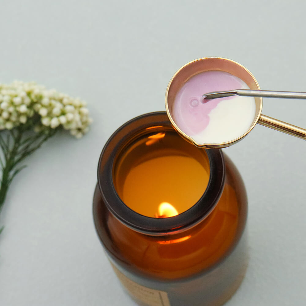 Mixing melted wax with a stirring stick